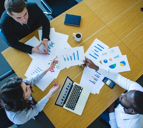 Team analyzing regulatory data and insights for compliance strategy